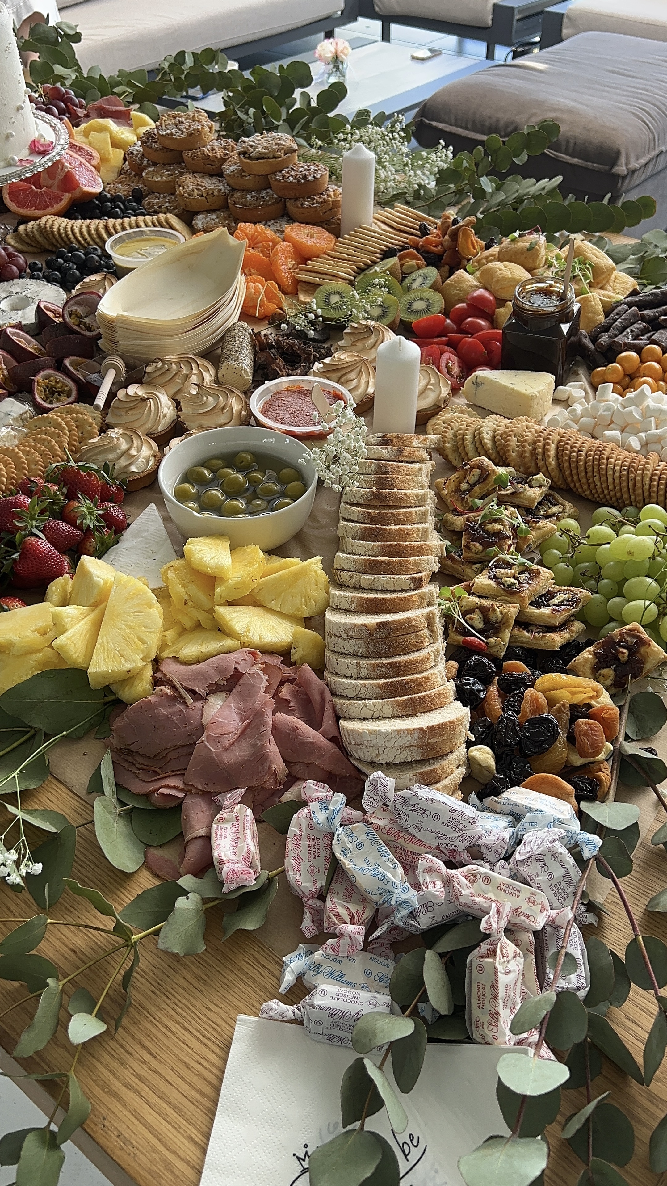 A grazing table with a tall stacked-bread tower